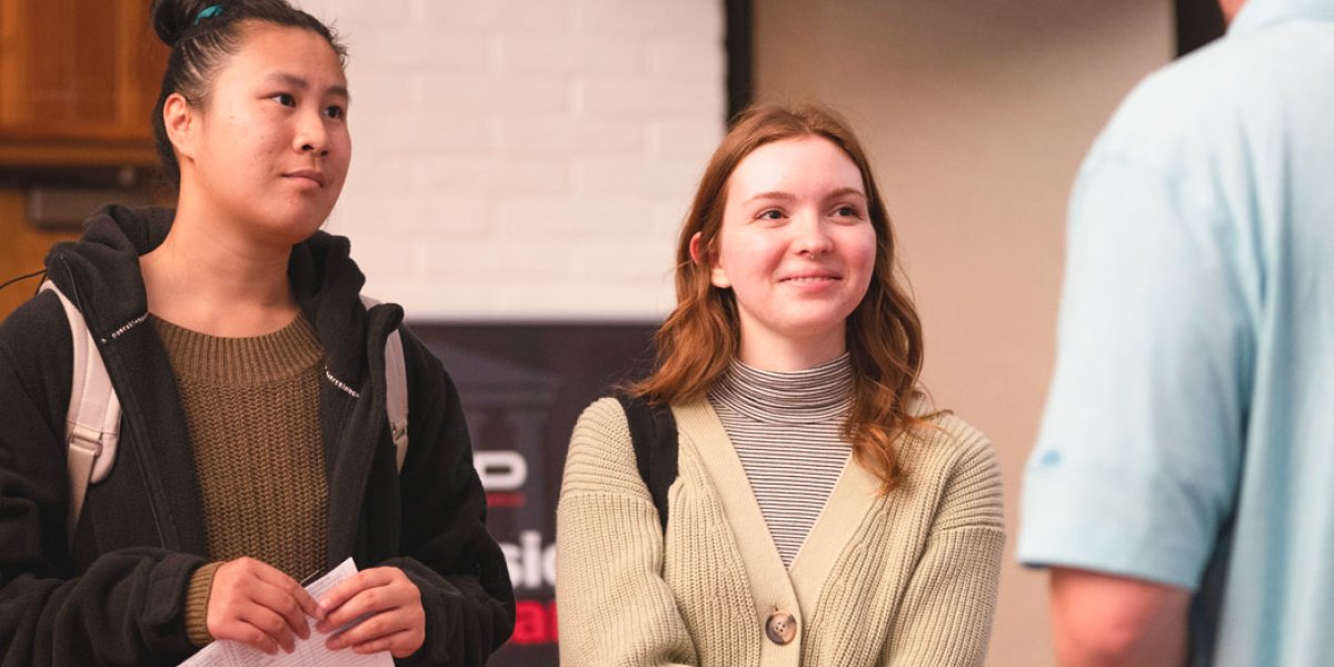 two saint mary's students speaking with recruiter