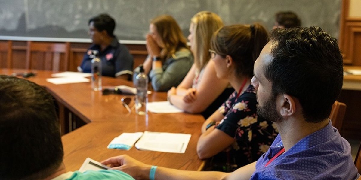 Students sitting in a class listening to a speaker