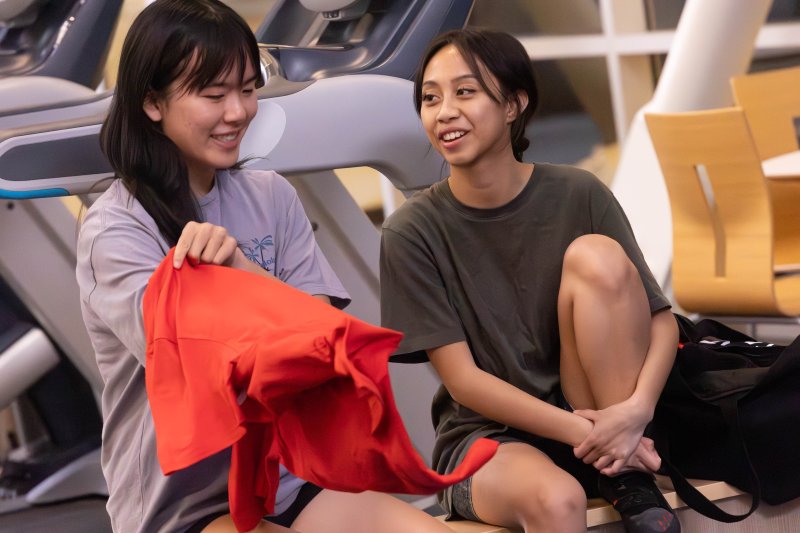 Prepare to Climb: Shelby Fong ‘27 and Kierce Alvarez ‘27 prepare to participate in the Climbing Wall Event sponsored by Residence Hall Association and Campus Recreation. / Photo by Rebecca Harper