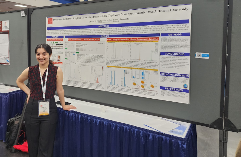 Megan Bindra '23 stands in front of poster at conference