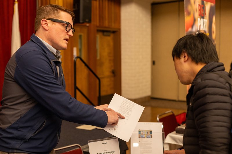 Recruiter conversing with a career fair attendee