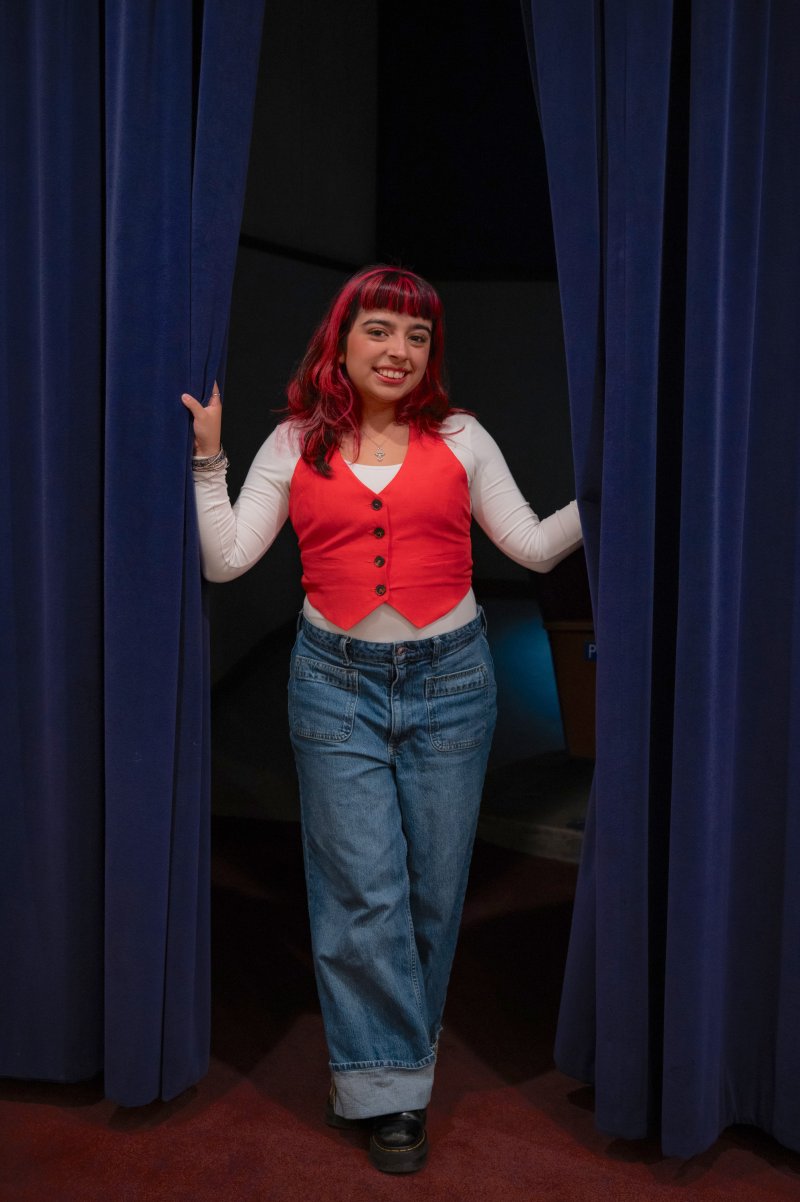 Bianca Langlois '27 standing between curtains at LeFevre Theatre