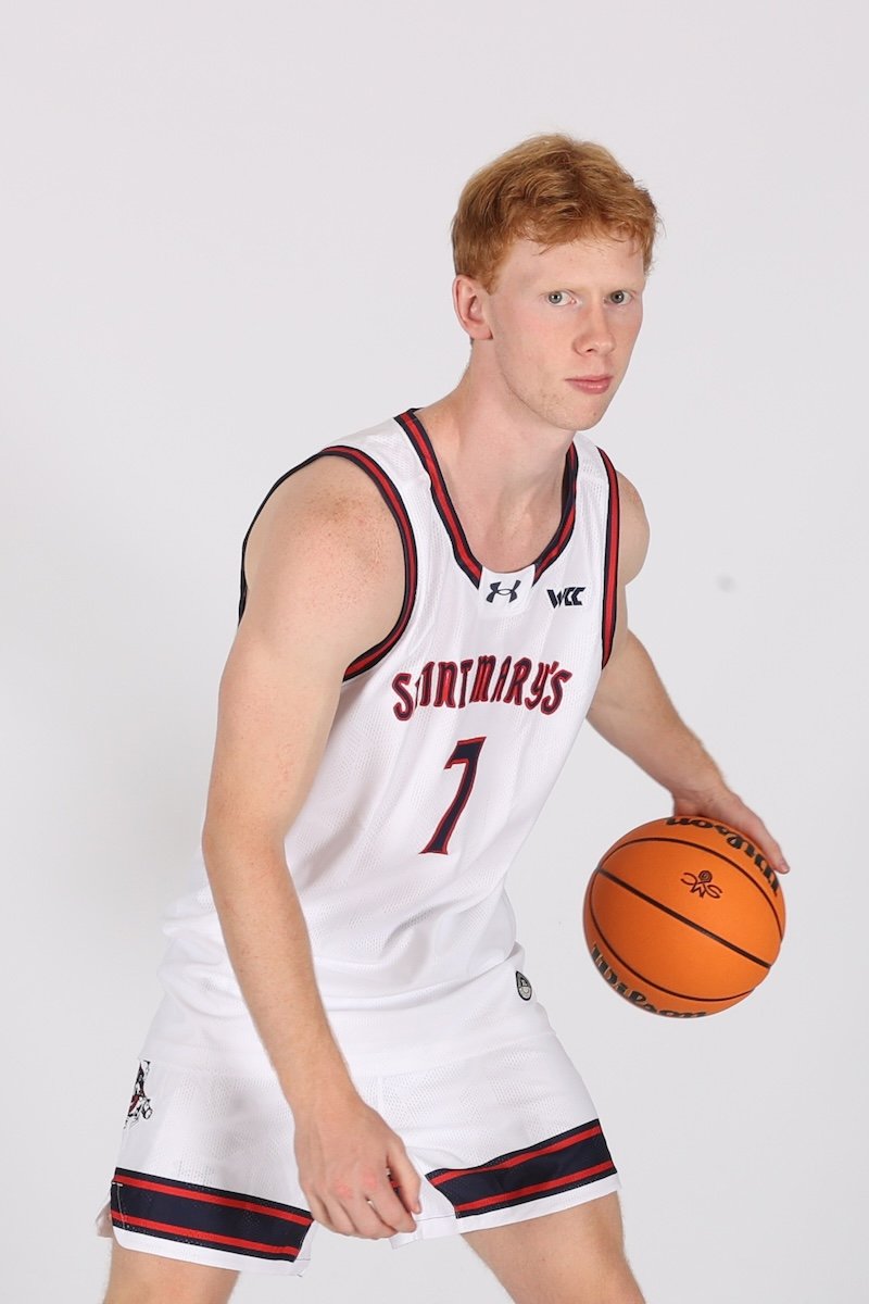 Men's basketball player Joshua Dent with a basketball