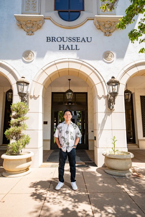 Jian Bumatay posing outside of Brousseau Hall