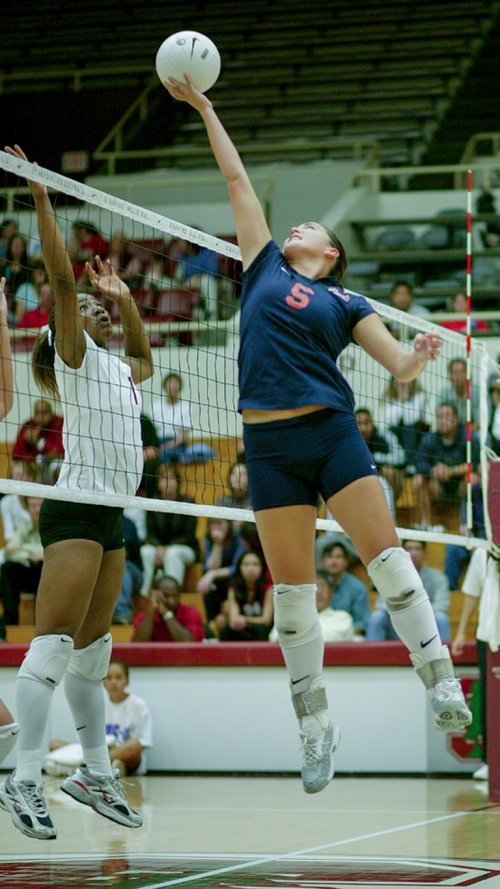 Mandy Bible hits volleyball over the net