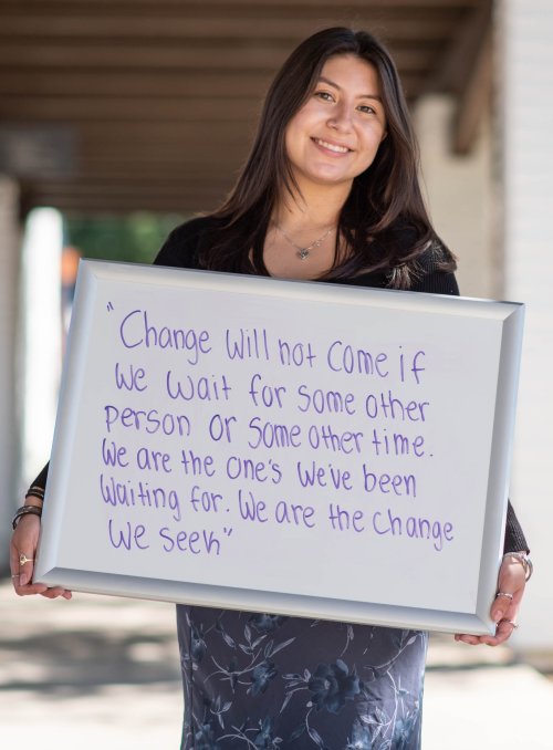 Ashley Hernandez posing with her favorite Barack Obama quote: "Change will not come if we wait for some other person, or if we wait for some other time. We are the ones we've been waiting for. We are the change that we seek."