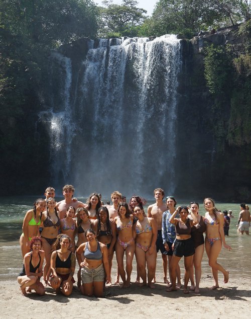 Students in front of a waterfall