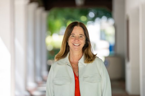 Headshot of woman standing in corridor