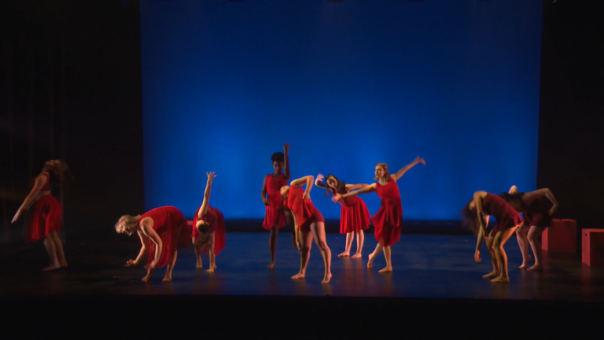 Women in red dance on stage