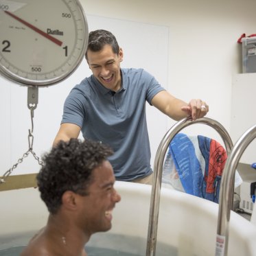 A student in an immersion tub in a Kinesiology class