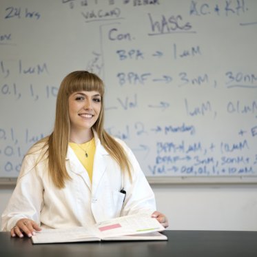 student in front of board