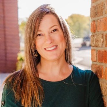portrait next to brick wall