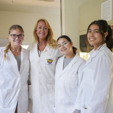 3 research students with mentor in laboratory