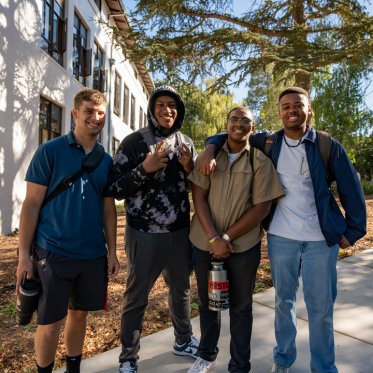 Students standing together smiling