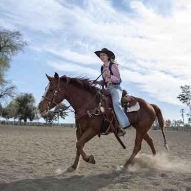 A student riding a horse