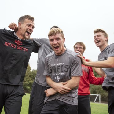 Soccer players yelling together in a circle