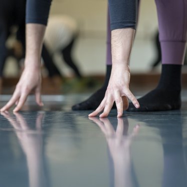 Dancers hands and feet on floor