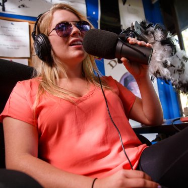 A student doing a radio podcast