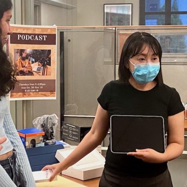 A women is holding an ipad and explaining