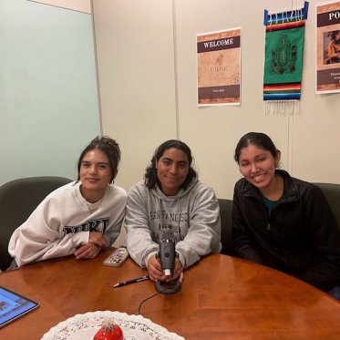 three women sitting and smiling