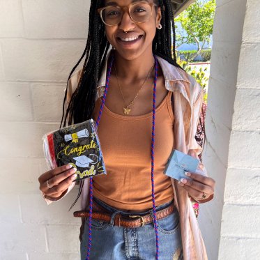 girl holding a tag saying congrats