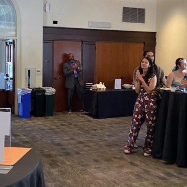 group of people standing around a table