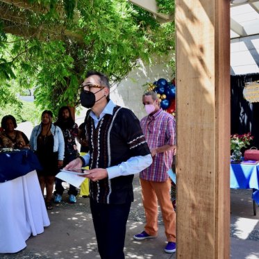 man wearing a mask and waiting in line