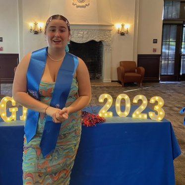 women wearing stole standing Infront of a table