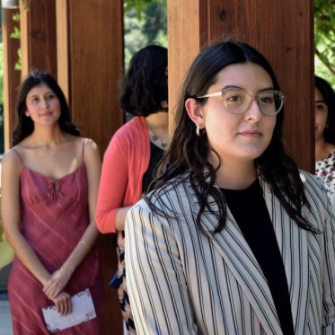 women leaning on the a pillar