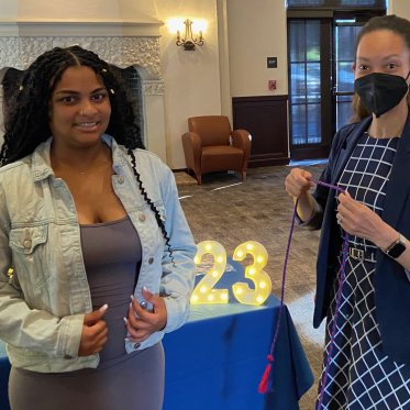 two women standing and smiling
