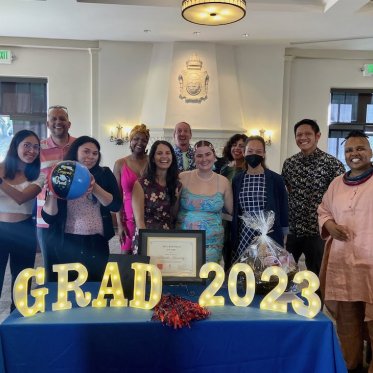 group of people smiling and standing closely 