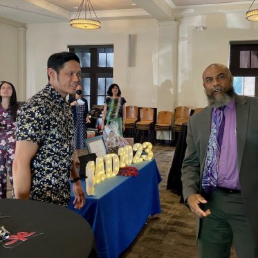 group of people standing around a table