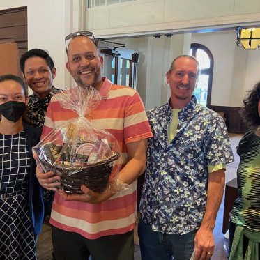 group of people smiling and standing closely 
