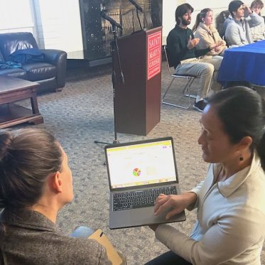 women showing something on the laptop