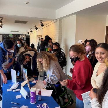 group of students standing around a table
