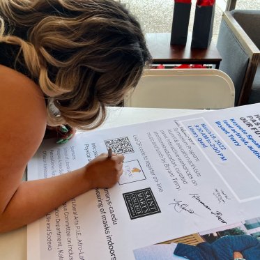 woman writing on a big poster