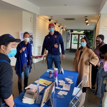 group of people standing around a table
