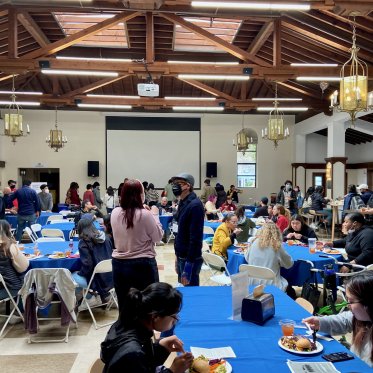 students sitting around the table and dining