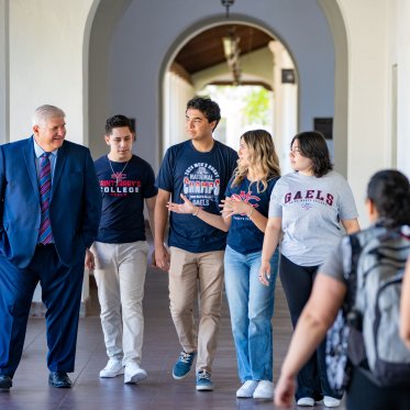 Roger walking with students