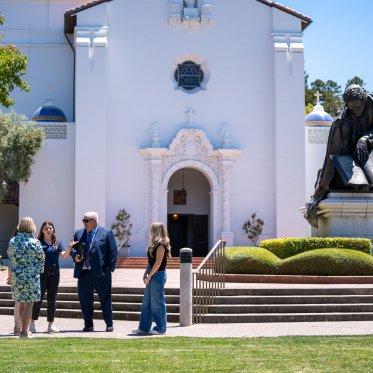 Roger in front of Chapel with students