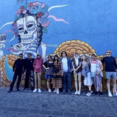 Students in front of a mural