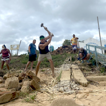 Student swinging sledgehammer