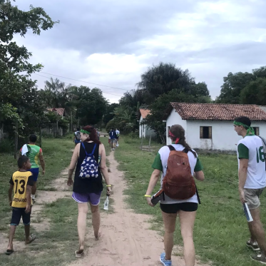 Students walking with local children