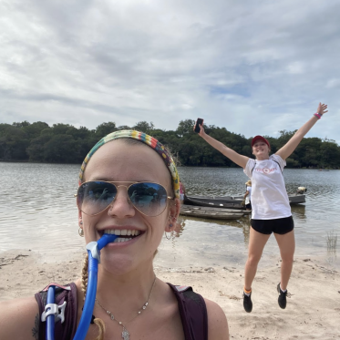 Students on a beach with a boat