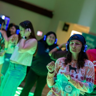 Senior, Maddie Heimer vibing to music at the silent disco at CAB Carnival.