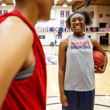 Students on a basketball courtJ