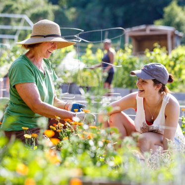A Student and faculty member gardening in the legacy garden