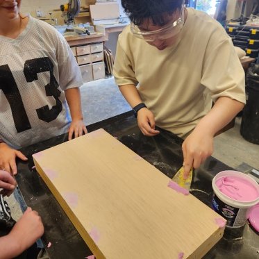 students painting theatre props pink