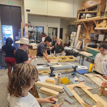 Group of students in a woodshop building theatre props