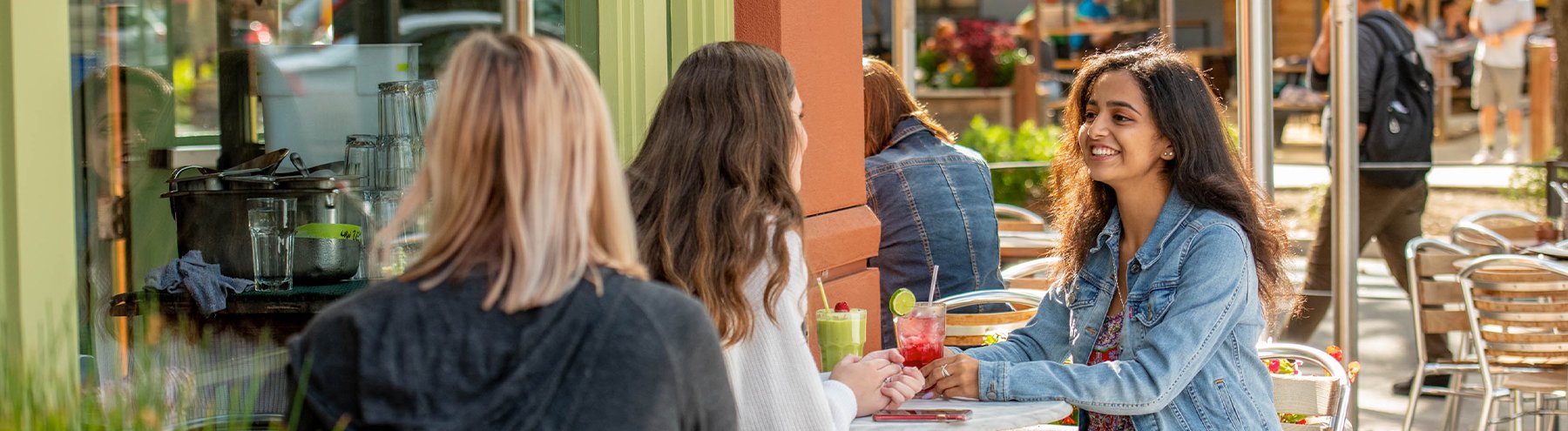 Student talks with friends at a cafe